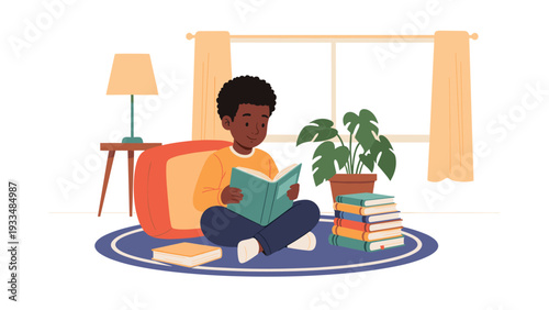 Young boy sits comfortably on a rug in a living room and reads a book, surrounded by his own stack of favorite stories.