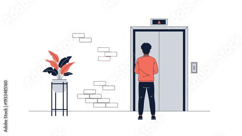 Young man with dark hair stands with his back to the viewer waiting for the elevator doors to open in a modern building hallway.