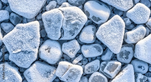 Close up of frozen pebbles covered in frost and ice crystals winter cold