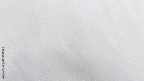 White fabric texture with delicate hexagonal pattern creating a soft transparent background for wedding concepts