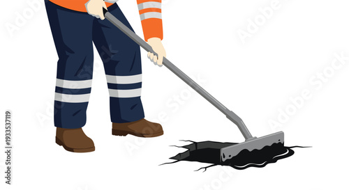 A construction worker, dressed in orange and navy safety attire, is actively using a long-handled tool to spread black asphalt into a cracked ground surface.