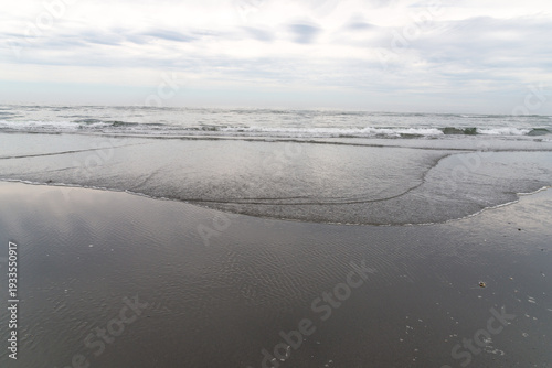 USA, WA, Queets, Olympic National park.  Waves lapping gently on the beach on the west coast of the Olympic Peninsula.  Looking west over the Pacific Ocean.