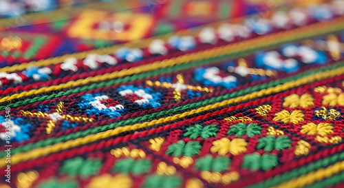 Close-up view of a vibrant, intricately embroidered textile showcasing traditional patterns and rich colors.