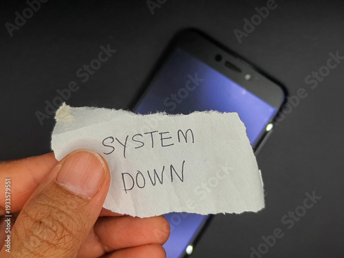 A hand holding a handwritten 