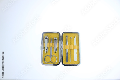 Compact manicure pedicure kit with nail clippers, scissors and tweezers in travel case isolated on white background. Personal grooming, nail care tools for hygiene, beauty treatment, daily self  care 