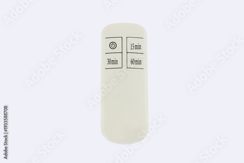 Minimalist remote control with four clearly marked buttons, isolated on white background. White plastic casing has soft rounded edges. Buttons labeled power, 15 min, 30 min, and 60 min, simple design 