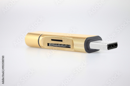 Gold USB-C OTG flash drive adapter with SD and microSD memory card reader isolated on white background. Portable storage device for smartphone, tablet and laptop data transfer, digital backup and save