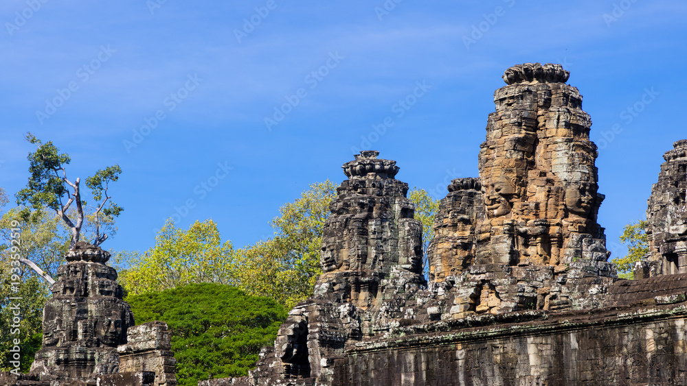 Fototapeta premium Bayon Temple stone faces rising in Angkor Thom, Cambodia