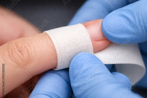 Doctor Wrapping Finger Bandage Medical Wound Dressing Close Up for Clinical Care First Aid and Procedural Documentation