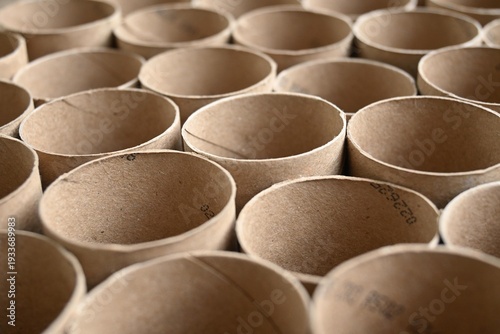 Close-up of stacked empty brown cardboard paper tubes and cores.