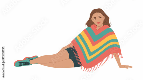 Relaxed woman in colorful poncho and shorts lounging on floor with casual footwear