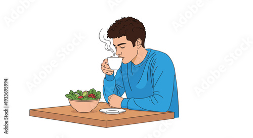 Young man sitting at a table enjoying a hot cup of coffee with a fresh green salad in a quiet moment of dining or break.