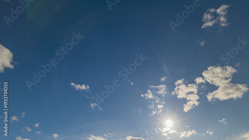 The beautiful blue sky with wispy clouds and bright sunlight creates a serene atmosphere