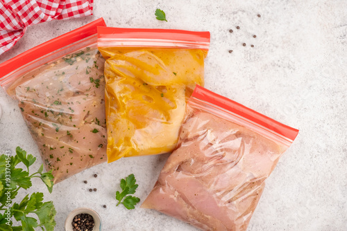 Food preparation for future meals with marinated chicken in sealed bags on a countertop