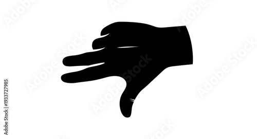 Silhouette of a hand making a dog shadow puppet.