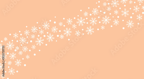 Festive winter background with white snowflakes falling diagonally on a light orange or peach colored backdrop.
