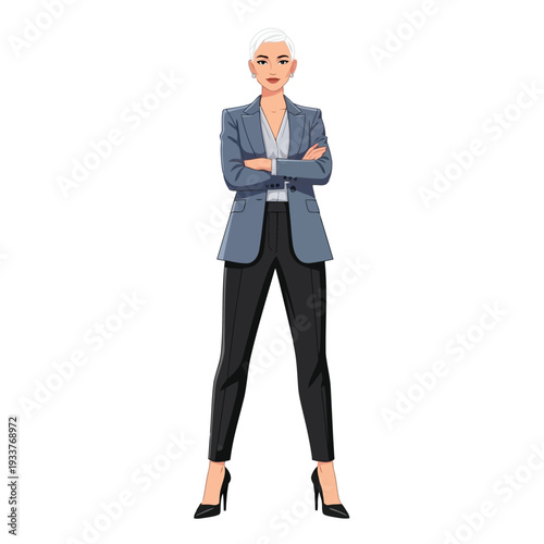 A woman with short blonde hair in a grey blazer and black pants stands with her arms crossed