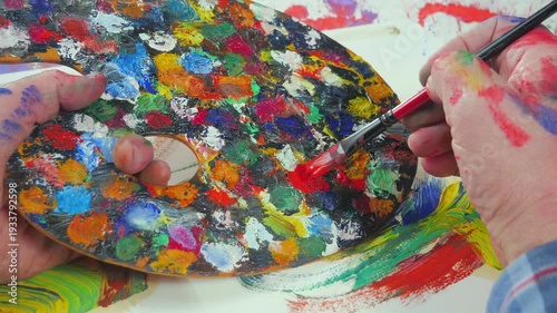 Wallpaper Mural The hands of the artist, work to create creative images in art. Art paints and brushes, applying multi-coloured strokes to the canvas using palette, gouache and watercolour. Torontodigital.ca