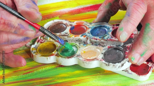 Wallpaper Mural The hands of the artist, work to create creative images in art. Art paints and brushes, applying multi-coloured strokes to the canvas using palette, gouache and watercolour. Torontodigital.ca