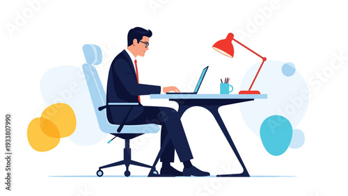 Professional businessman in a suit works late at a modern desk with his laptop computer and a bright red lamp.