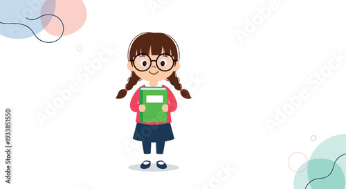Studio portrait of a young schoolgirl with glasses and pigtails holding a green book against a white background with soft accents.