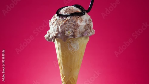 Wallpaper Mural Ice cream in a waffle cone slowly rotates around its axis against a bright background, with chocolate fudge drizzled on top. Torontodigital.ca