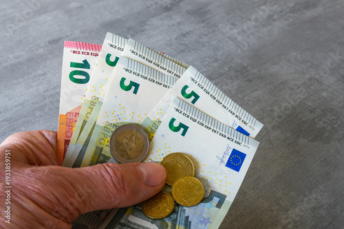 Foto Hand Holding Euro Banknotes and Coins Close Up European Money and Finance Concep