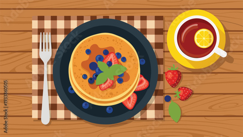 Delicious stack of pancakes with maple syrup, blueberries, and strawberries on a plate served with a cup of hot lemon tea.