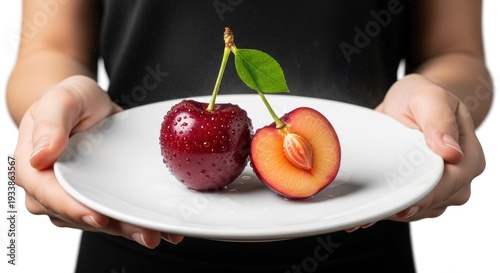 A plate showcasing a peach and a plum with vibrant freshness and natural beauty