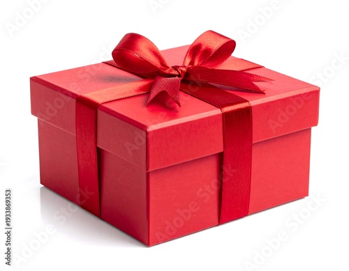A square red gift box tied with a matching ribbon and bow, resting on a white surface, casting a subtle reflection