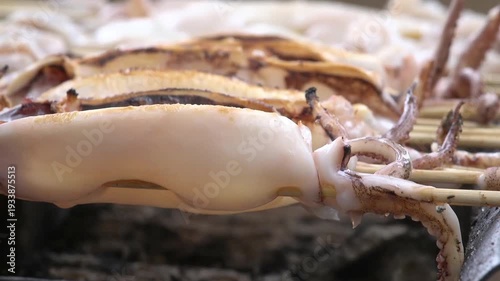 Grilled squid skewers sizzling on barbecue