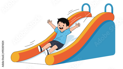 Happy little boy wearing a blue shirt sliding down a colorful playground slide with his arms raised high in joy.