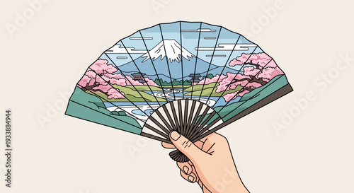 Hand holding Japanese fan with Mount Fuji and cherry blossoms