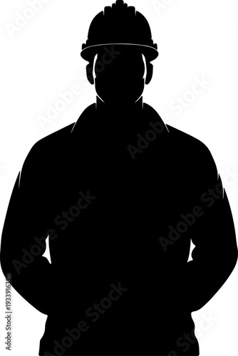 Silhouette of a worker wearing a hard hat standing confidently with hands in pockets