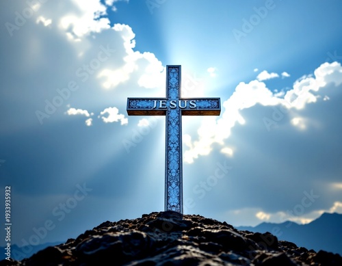 An imposing cross standing atop a rocky hill against the backdrop of a clear blue sky dotted with fl