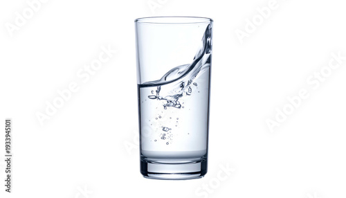 A tall glass filled with clear liquid, some of which is dynamically splashing, against a black background