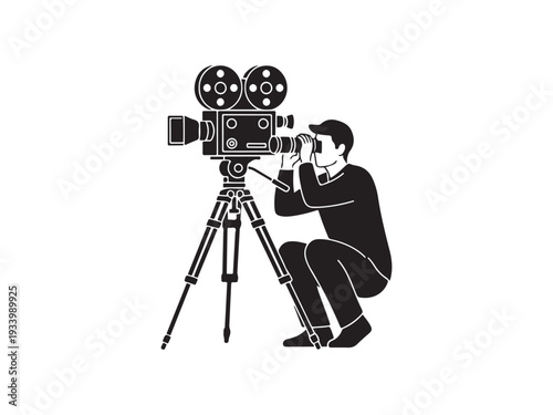 Man operating old film camera on tripod in studio.