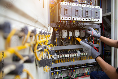 Photography Electrical service technician use electricity measuring tools equipment checking electric current circuit breaker terminal panel and cable wiring main power distribution board for maintenance system