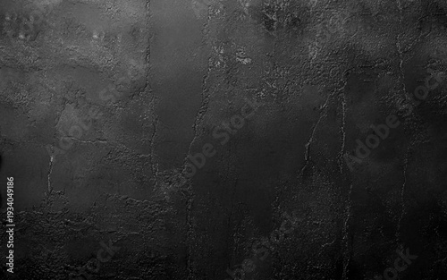 Black decorative plaster texture with vignette. Abstract grunge background with copy space for design.