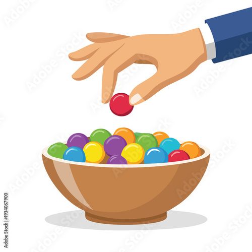 Hand selecting colorful ball from a bowl