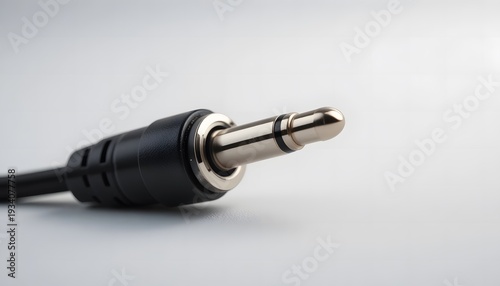 Close-up view of a standard 3.5mm audio jack plug on a black cable. aux cord