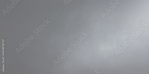 A seamless brushed metal texture features a shiny silver stainless steel plate with a smooth metallic gray pattern making it an ideal material backdrop or wallpaper surface