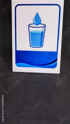 Illustration of a Glass of Fresh Water with a Single Water Drop Falling for Hydration and Health Concepts