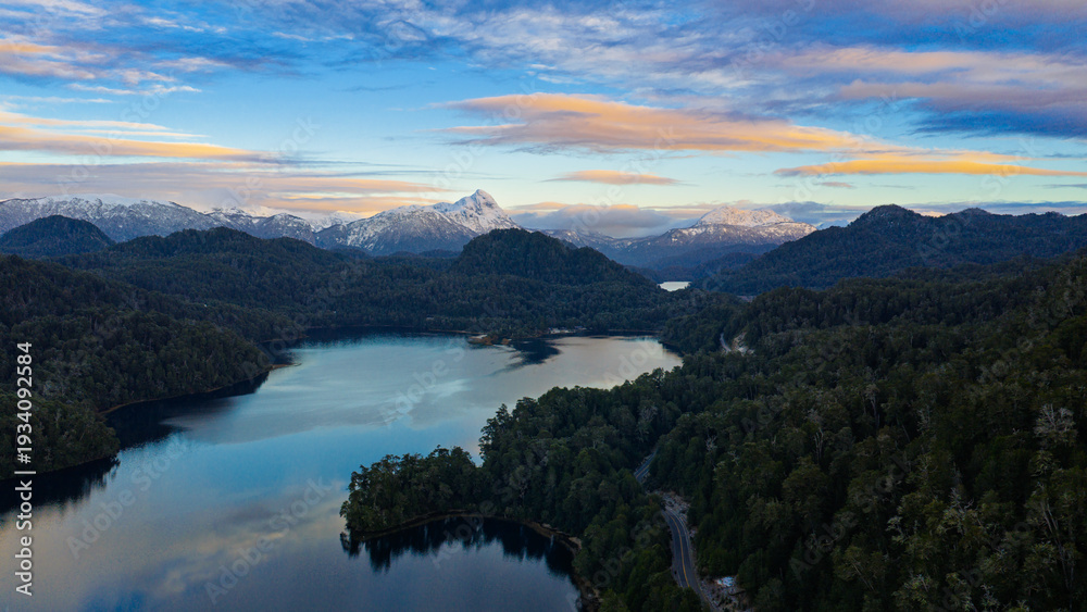 Fototapeta premium Panoramic aerial view of lakes and snow-capped Andes mountains along the scenic Seven Lakes Route in Patagonia, Argentina.