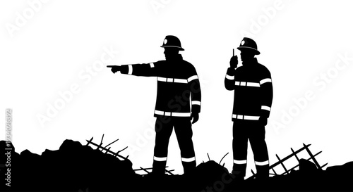 Firefighters standing on rubble debris communicating with radio and pointing