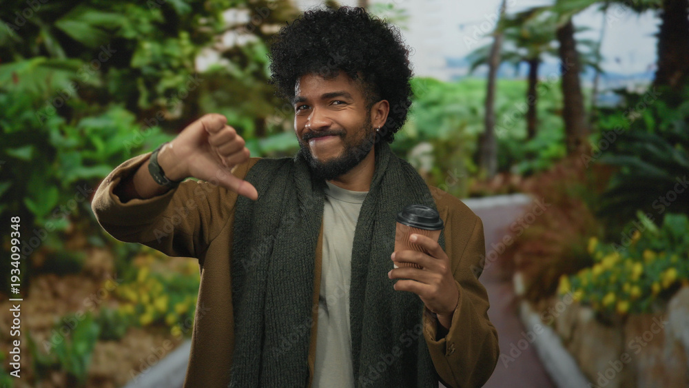 Fototapeta premium Man expressing disapproval holding coffee cup outdoors in lush green park setting capturing vibrant outdoor atmosphere