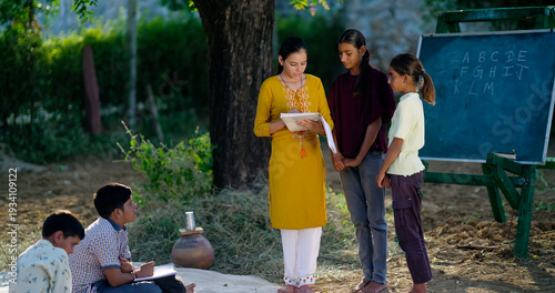 Photography Indian young adult female hold book do study helping to read teen age girl class rural area place