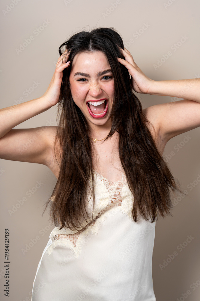 Fototapeta premium Young woman showing excitement in lace camisole