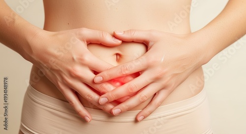 Wallpaper Mural Close-up of torso with hands on abdomen, subtle red light leak suggesting discomfort and skincare Torontodigital.ca
