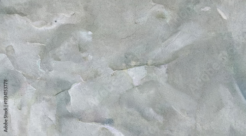 Close-up of crumpled light gray paper texture with soft folds and subtle fibers. Abstract neutral background ideal for design projects, stationery mockups, and vintage layouts.